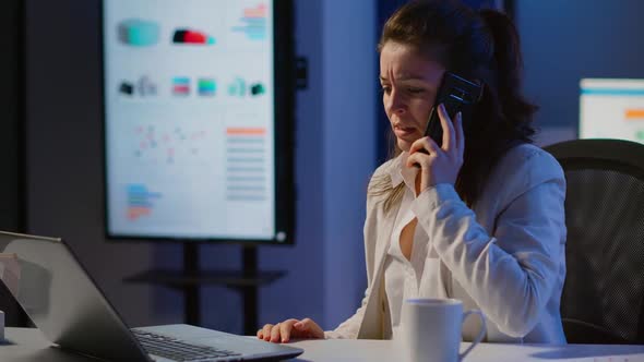 Angry Business Woman Having Phone Call in Startup Office Late at Night