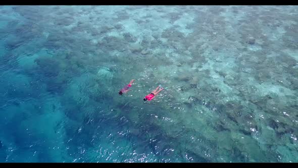 Aerial flying over panorama of relaxing bay beach break by clear lagoon and white sandy background o