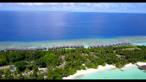 Aerial drone shot landscape of tranquil island beach break by transparent sea with white sandy backg