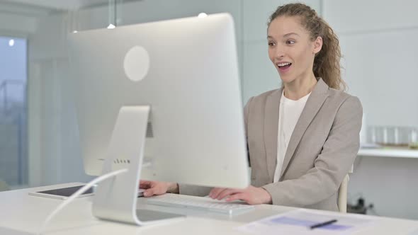 Ambitious Young Businesswoman Celebrating Success in Office 