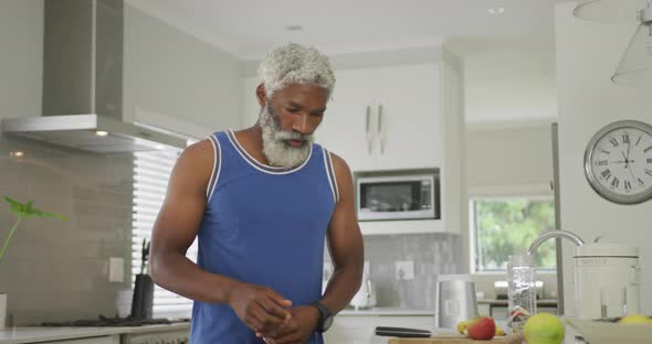 Video of african american senior man preparing smoothie