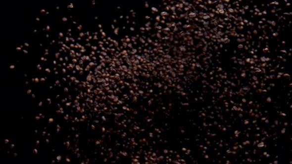 Coffee Grains Pile Falling Down on Black Background