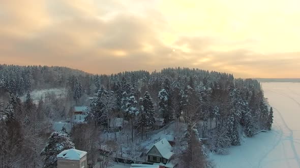 Flying Above Rural Winter Landscape At Sunset