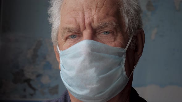 Portrait Of Old Caucasian Man In Protective Face Mask Looking At Camera Close Up