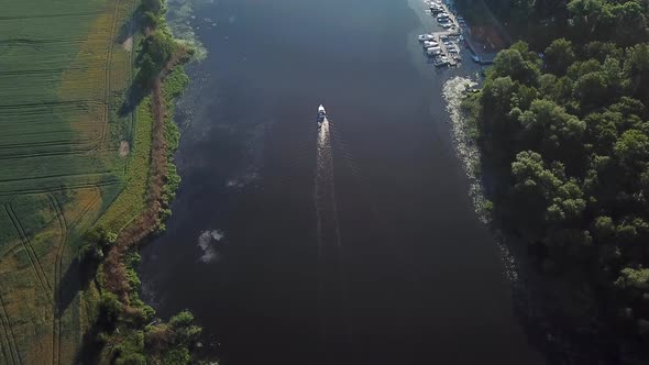 Aerial: boat on the river at dawn