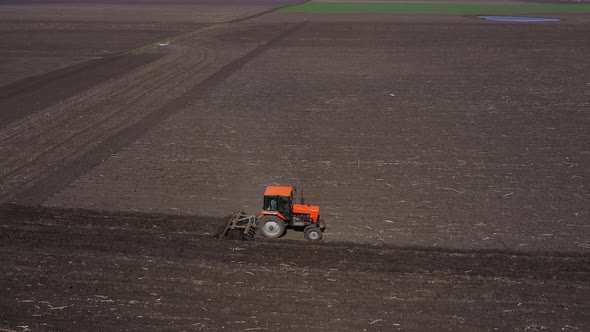 Red Tractor On The Field Aerial View