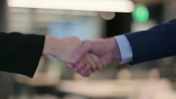 Hands Close Up of Businessman and Businesswoman Shaking Hands