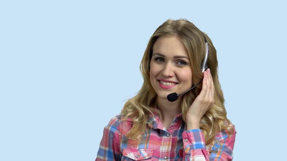 Beautiful Call Center Operator with Headset Talking with Someone
