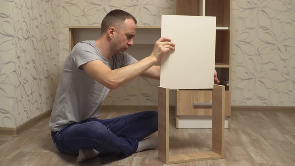 a Man Assembles Furniture