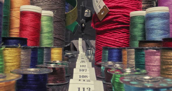 Antique tailor's workshop with tape measure and threads on spools.