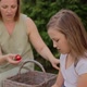 Smiling Mother Feeding Strawberry to Daughter in Backyard - VideoHive Item for Sale