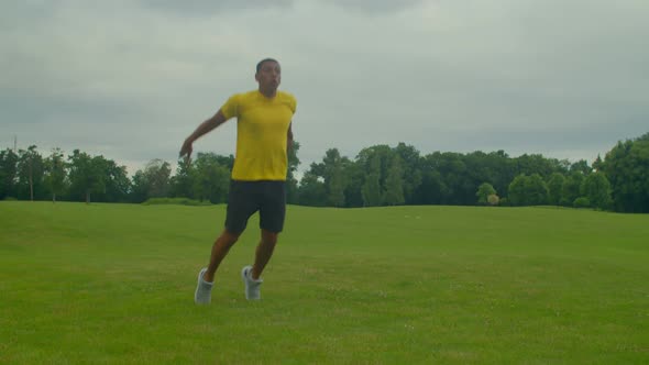 Athletic Handsome African Man Doing Squats to Broad Jump Exercise in Nature