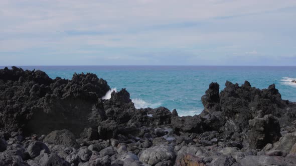 Waves crashing into shore on Hawaii