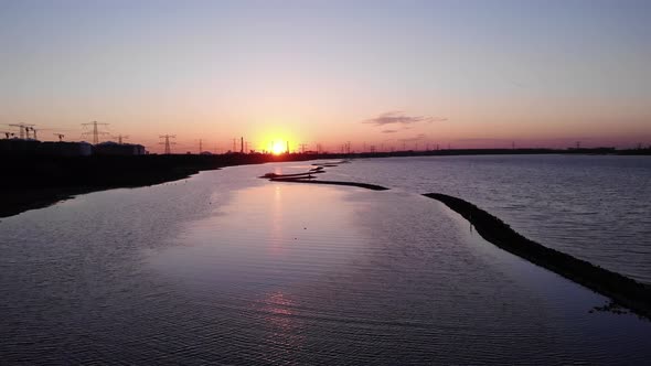 Beautiful Sunset View With Birds Flying Over Tranquil Waters At Maasvlakte In Brielse Meer, Netherla