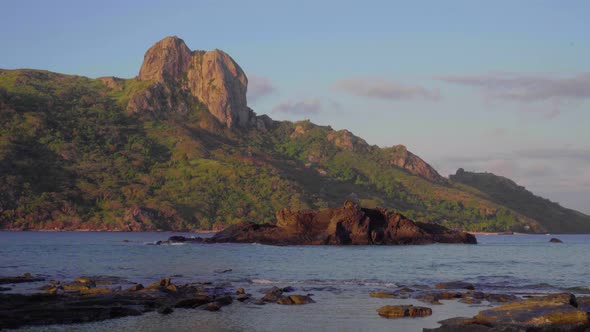 A beautiful rock mountain island in Fiji during sunset - wide shot