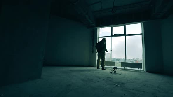 Person in Protective Suit Sanitizes Room in Building.