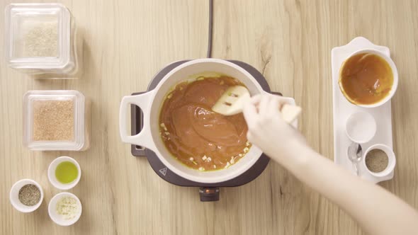 Chef Mixing Red Soup with Garlic in a Boiling Pot, Top View Static.