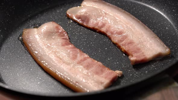 Closeup View of Bacon Slices in Frying Pan