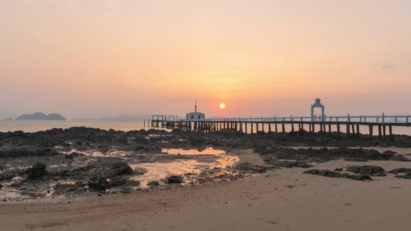 Timelapse The Small Pier Juts Out Into The Sea In Sunrise.