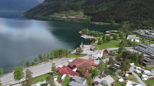 Aerial view from the town of Kinsarvik Norway with Hardangerfjord on a sunny day and ferry arriving