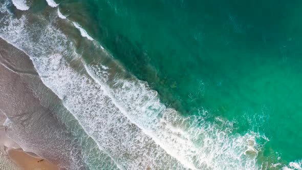 Aerial View of the Mediterranean Coast Waves Reach the Deserted Sandy Beach