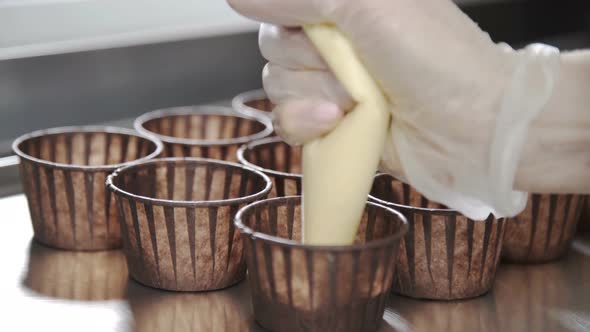 Put Dough Into Paper Cups. Professional Pastry