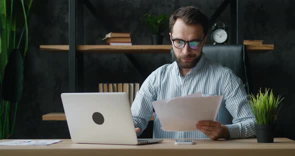 Portrait of a Male Businessman Has Stress While Working at the Computer