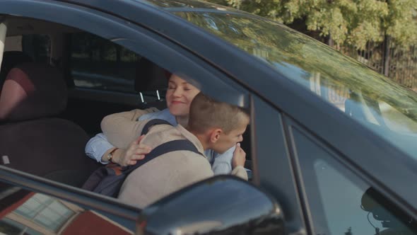 Cheerful Mother Dropping Son Off at School