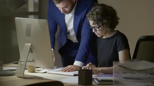 Coworkers Discussing Documents in Office