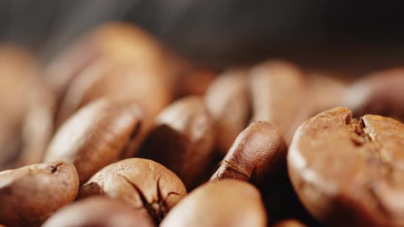 Arabica Quality Roasted Coffee Beans Spin on a Rotating Plate with Smoke