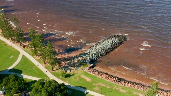 A foreshore or beach withing waves and a rock jetty, Located in Redcliffe, Brisbane, Australia.