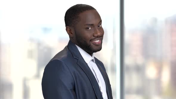 Afro-american Man Winks with Eye.