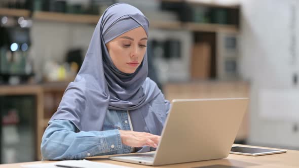 Professional Young Arab Woman at Work Using Laptop