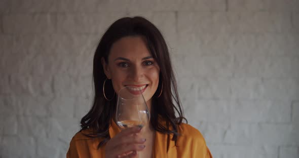 Beautiful Woman Drinks Water From a Glass