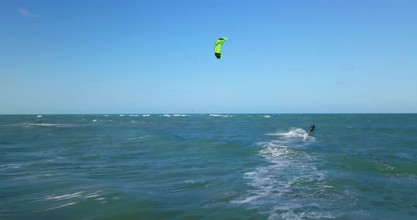 Aerial drone view of a man kiteboarding on a kite board