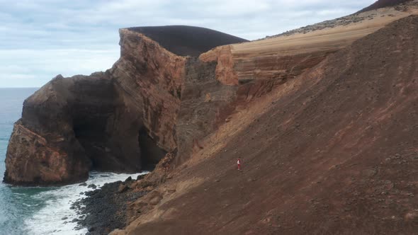 Man Standing on Hill of Capelinhos Volcano Faial Island Azores Portugal