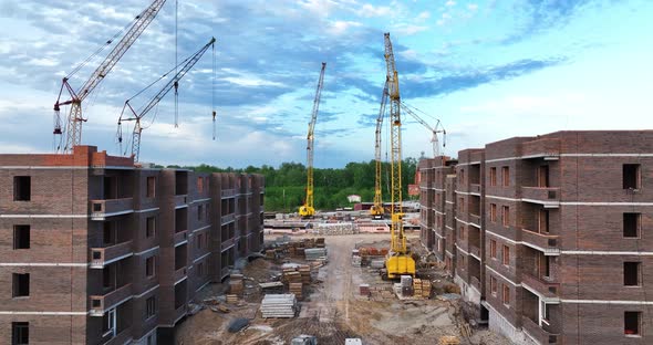 Construction site of low-rise brick houses in summer. Aerial view