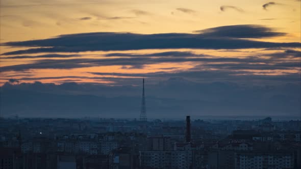 Timelapse City on a Background of Clouds at Sunset