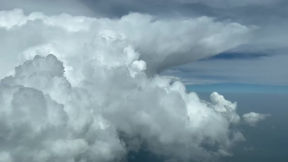 Aerial side view of a huge cumulonimbus from a jet cockpit during cruise level af 35000 ft. Pilot PO