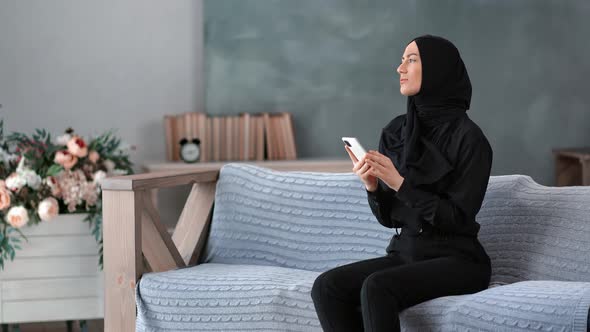 Modern Arabic Lady in Hijab Chatting Typing Message Use Smartphone