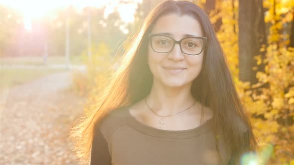 The Girl with a Beautiful Smile Goes to the Camera and Smiling