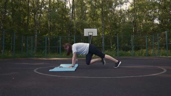 Woman in the Park on the Playground is Engaged in Active Cardio Workout alt
