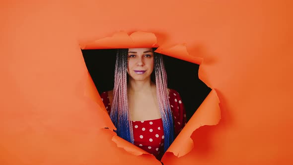 Smiling Woman with Senegalese Braids in a Hole in the Wall