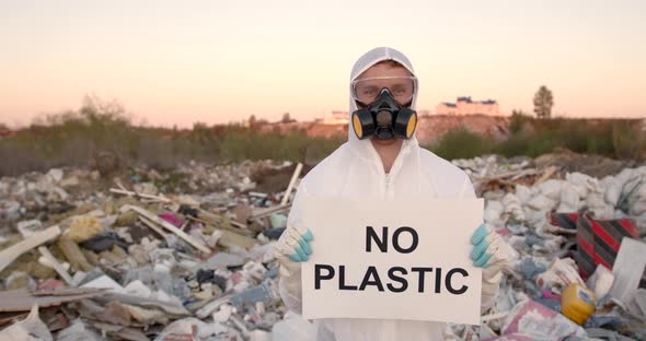 Man in Coverall Holding Anti Poluttion Sign