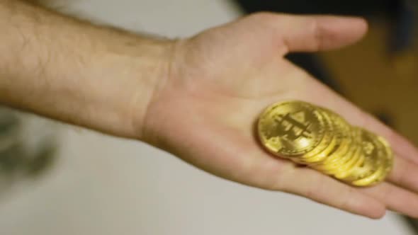 Slow Motion Metal Model in Person Hands Made As Bitcoin Currency