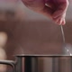 Slow Motion Man Hand Stir Fettuccine Pasta in Saucepan with Boiling Water Closeup - VideoHive Item for Sale