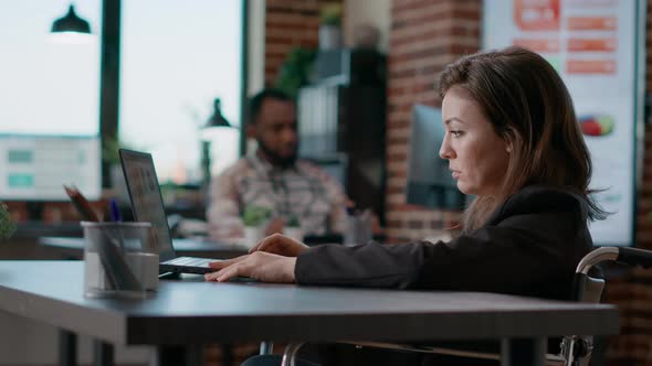 Portrait of Female Employee Analyzing Statistics on Laptop