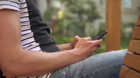 Close Up of a Mans Hands Holding Mobile Phone