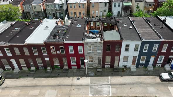 Boarded up homes in inner city America. Poverty in urban community in USA. Aerial tilt up reveal on