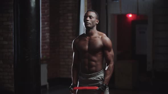 A Black Handsome Man Pumping His Hands Muscles in the Gym